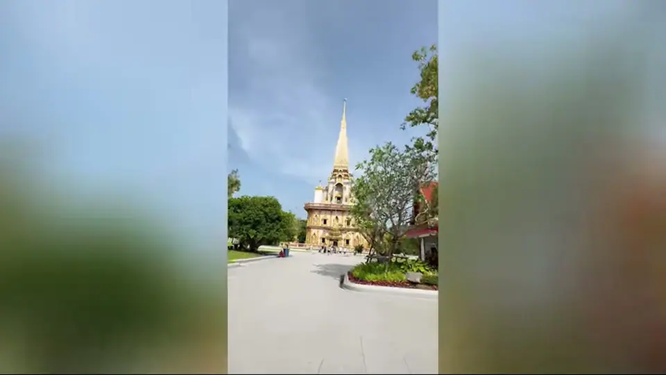 Golden Wat Chalong chedi at the end of a broad approach.
