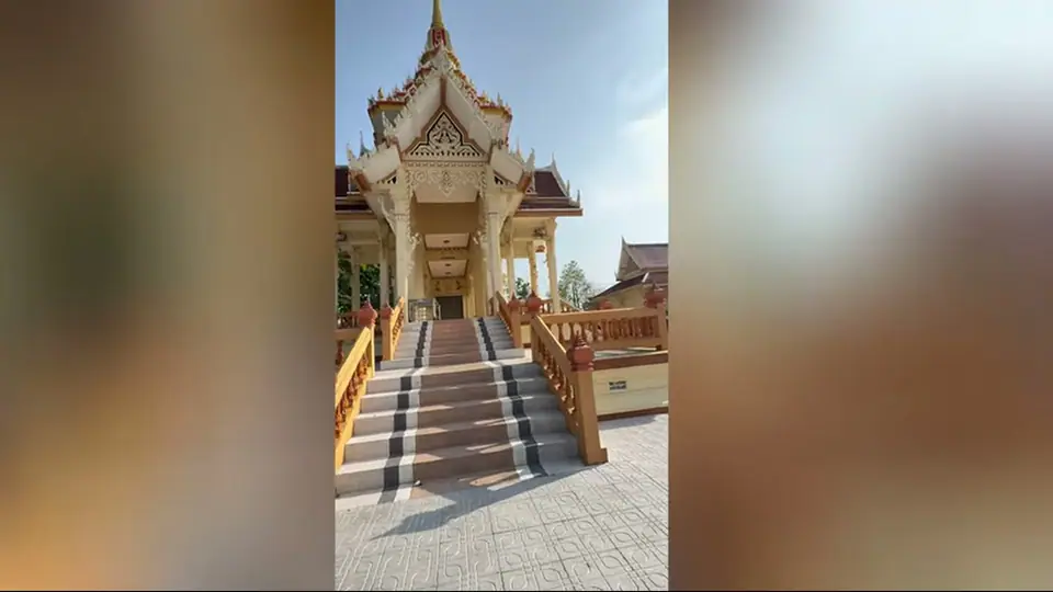 Centered staircase leading to a shaded entrance with carved gable.