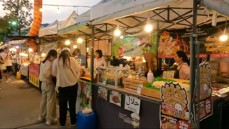 Full glowing Chillva Market sign with scooters parked along the road